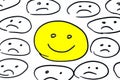 Smiley happy among sad smileys Royalty Free Stock Photo