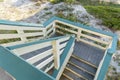 Destin, Florida- Wooden staircase with green handrails and yellow balluster view from above