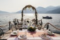 Destination wedding arch and banqouet covered table at sunset Royalty Free Stock Photo