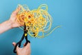 Destroy optical fiber with scissors. Isolated on blue Royalty Free Stock Photo