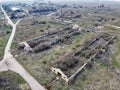 Destroyed agricultural buildings, aerial view. Abandoned livestock farm