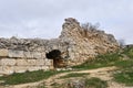 Destroyed antique fortress wall with arch and masonry from different centuries