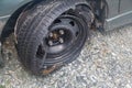 Destroyed blown out tire with exploded, shredded and damaged tire on a modern automobile. damaged truck rubber after tire explosio