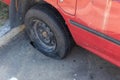 Destroyed blown out tire with exploded, shredded and damaged tire on a modern automobile. damaged truck rubber after tire explosio