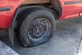 Destroyed blown out tire with exploded, shredded and damaged tire on a modern automobile. damaged truck rubber after tire explosio Royalty Free Stock Photo