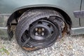 Destroyed blown out tire with exploded, shredded and damaged tire on a modern automobile.