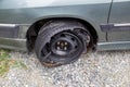 Destroyed blown out tire with exploded, shredded and damaged tire on a modern automobile. Royalty Free Stock Photo