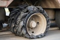 Destroyed blown tire with crushed and damaged rubber on a truck.