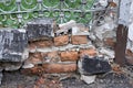 Destroyed brick wall. Many small debris. Old architecture