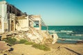 Destroyed building on the beach after a storm due to strong waves. Climate change Royalty Free Stock Photo