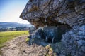 Destroyed bunker window, view from outside. Protruding rusty reinforcing wires. Poland, Wyrwidab bunker, Wegierska Gorka