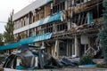 Destroyed civil infrastructure building, pile of fragments and broken glass in front of it