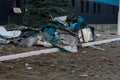 Destroyed civil infrastructure building, pile of fragments and broken glass in front of it. Military drones attack aftermath