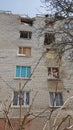 Destroyed facade of a five-story apartment building with broken