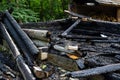 Destroyed by fire wooden house completely burned to the ground .ruins of a burnt wooden house after a fire Royalty Free Stock Photo