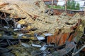 Destroyed industrial building. Insulated roof structures of an industrial building after fire and collapsing