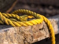 Destroyed light concrete slabs, tied with a thick yellow rope, cable. construction and replacement concept