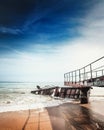 Destroyed metal pier during the tide of the sea