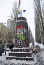 Destroyed monument to Lenin on Shevchenko boulevard, sculpture without head lying on pavement, people taking picture of