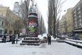 Destroyed monument to Lenin on Shevchenko boulevard, sculpture without head lying on pavement, people taking picture of