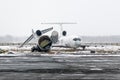 Destroyed old aircraft in the landfill at the airport in winter. Royalty Free Stock Photo