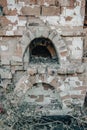 Destroyed old brick home stove concept photo. Damaged vintage oven on backyard.