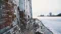 Destroyed old building red brick walls in middle of frozen lake