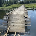 Destroyed old wooden bridge on the Ruza River in Russia Royalty Free Stock Photo