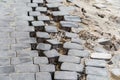 Destroyed paving stones on the footpath. Dismantling and construction of sidewalks in the city. Close-up Royalty Free Stock Photo