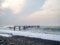 Destroyed pier under the waves. Bad weather at sea Royalty Free Stock Photo