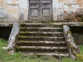 Destroyed porch and steps of the old mansion. Ruined entrance of former manor house