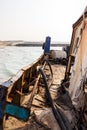 Destroyed and rusty deck of a cargo ship with old bridge, machinery and equipment, washed ashore Royalty Free Stock Photo