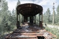 destroyed rusty railway carriage in the forest .