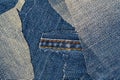 Destroyed torn denim blue jeans texture. Ripped denim blue cloth background