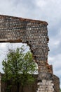 Destroyed wall. Fragments of the wall against the sky. Ruins of houses. Summer day