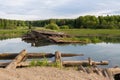 Destroyed wooden bridge across river near forest. Royalty Free Stock Photo