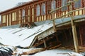 Destroyed wooden building due to heavy snow cover, collapses under snow Royalty Free Stock Photo