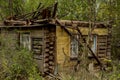 Destroyed wooden old houses in an abandoned village evicted during the Chernobyl accident at a nuclear power plant.