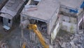 Destroying Old House Using Bucket Excavator on Construction Site. Royalty Free Stock Photo