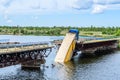 Destruction of bridge structures across the river with the collapse of sections into the water