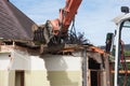Destruction of a building by a caterpillar crane Royalty Free Stock Photo