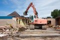 Destruction of a building by a caterpillar crane Royalty Free Stock Photo