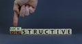 Destructive or constructive symbol. Male hand turns cubes and changes the word `destructive` to `constructive`. Business and Royalty Free Stock Photo