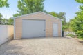 Detached gable garage exterior with steel walls and roll-up door with door latch lock Royalty Free Stock Photo