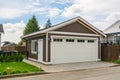 Detached garage of residential house with asphalt road in front. Royalty Free Stock Photo