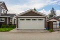 Detached garage of residential house with asphalt road in front. Royalty Free Stock Photo