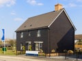 Detached new build home with black cladding. UK Royalty Free Stock Photo
