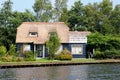 Traditional thatched roof Dutch house water lake , Giethoorn, Netherlands Royalty Free Stock Photo