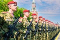 Detachment of fighters in red berets and green uniforms on Red Square in Moscow. Young armed soldiers. Russian army