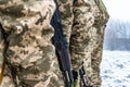 A detachment of soldiers with Kalashnikov assault rifles stand in formation to prepare for battle and offensive